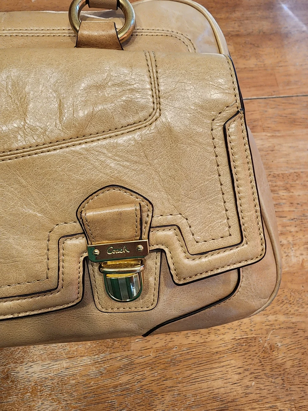 2011 Coach Poppy Push Lock Satchel features a beige leather exterior